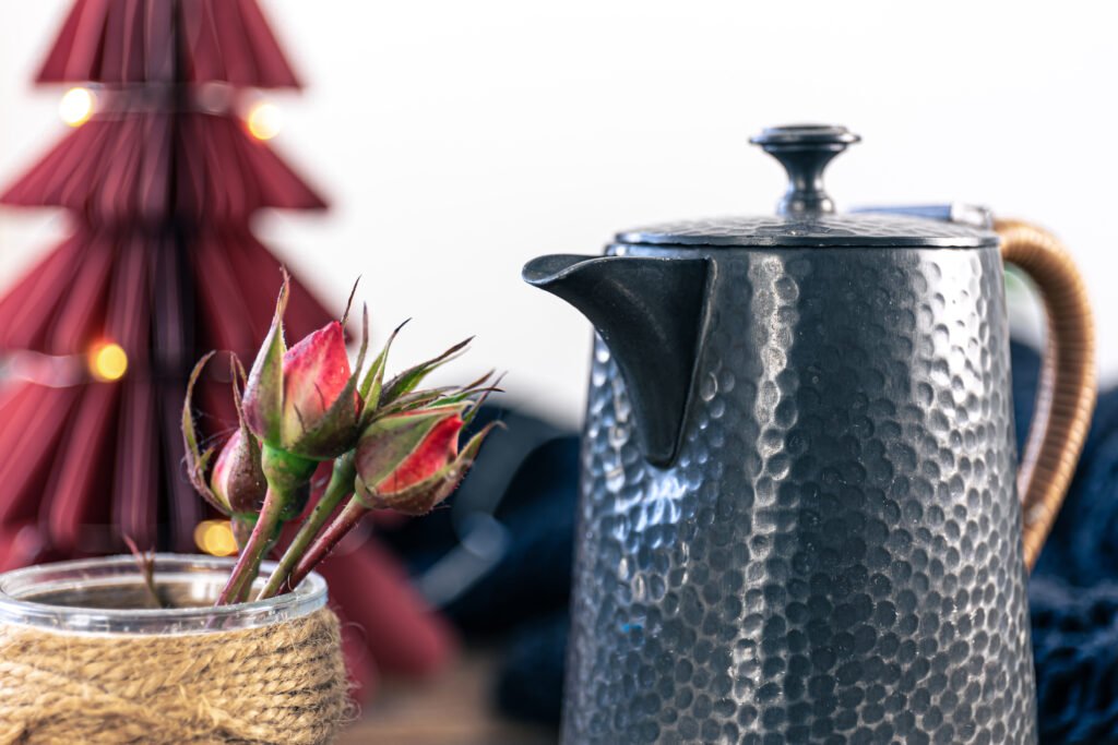 beautiful textural teapot on a blurred background in a cozy home interior.
