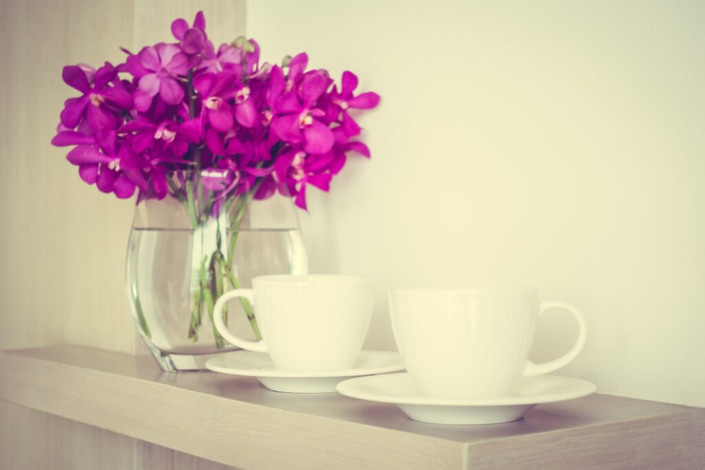 coffee cup with orchid flower vase