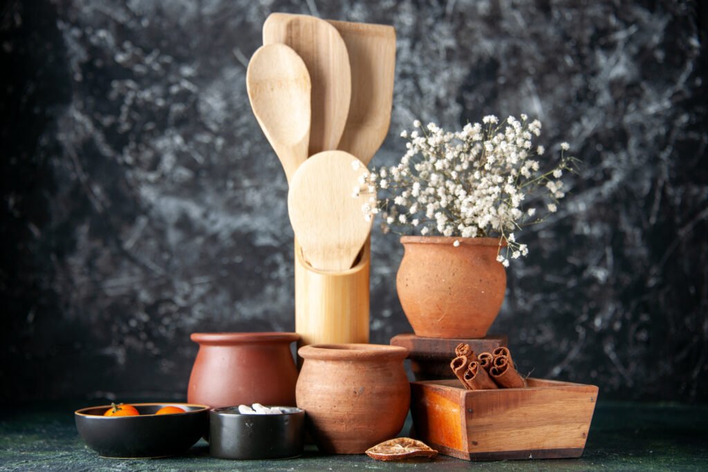 front view wooden spoons with pots cinnamon dark wall color seasoning salt food cutlery photo (2)